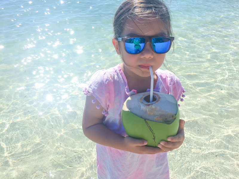 Fiji Castaway Island, Mamanuca Islands, girl with sunglasses and coconuts